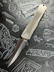 Pre Owned Heretic Knives Custom Manticore X D/E Hand Ground Vegas Forged Damascus, Hefted Stainless Steel Handle, Orange Peel Clip, Deep Engrave Logo, Carbon Fiber Button SN:007