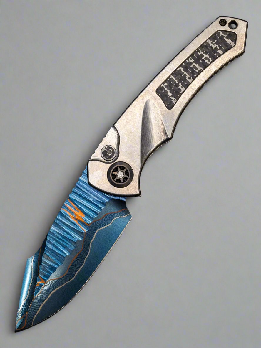 Pre Owned HERETIC KNIVES CUSTOM PARIAH- OTS AUTO- TITANIUM FRAME- FAT CARBON SNAKESKIN INLAY- BLUED BAKER FORGE ELITE AURORAMAI DAMASCUS BLADE- FAT CARBON SNAKESKIN BUTTON INLAY