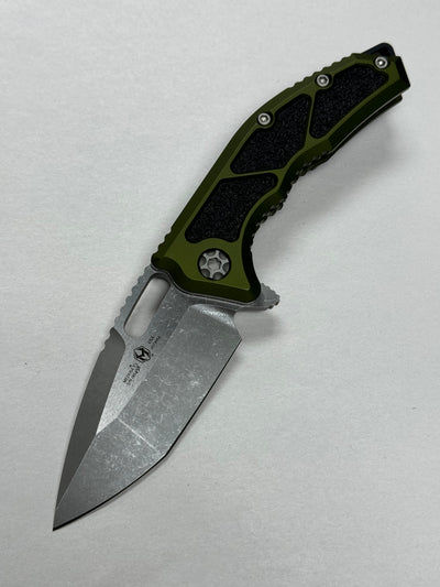Heretic Medusa Manual OD Green, Battleworn MagnaCut - H009-5A-GRN