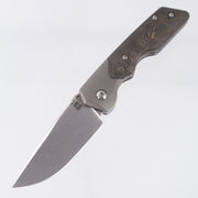 Attn2Detail Mercantile Mk.3 Medium Bolster Lock Gen4 Drop Point Rising Grind - Grey Stonewash Titanium w/ Brass Fukugo Fat Carbon Scales - Stonewash Satin Magnacut