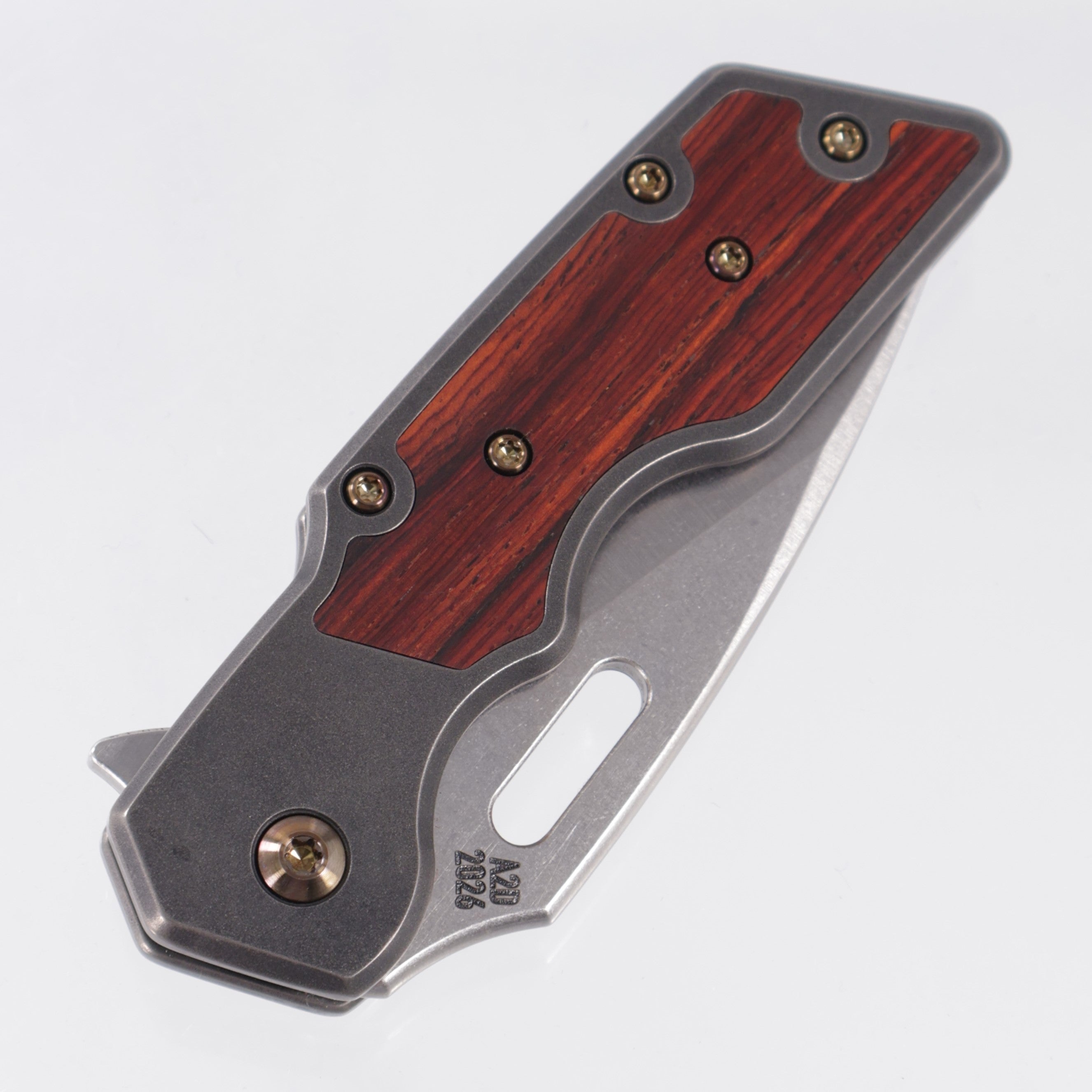 Attn2Detail Mercantile Mk.1 Medium Gen4 Drop Point Rising Grind - Blackened Titanium w/ Cocobolo Inlays & Gold Ano Hardware - Stonewash Satin Magnacut