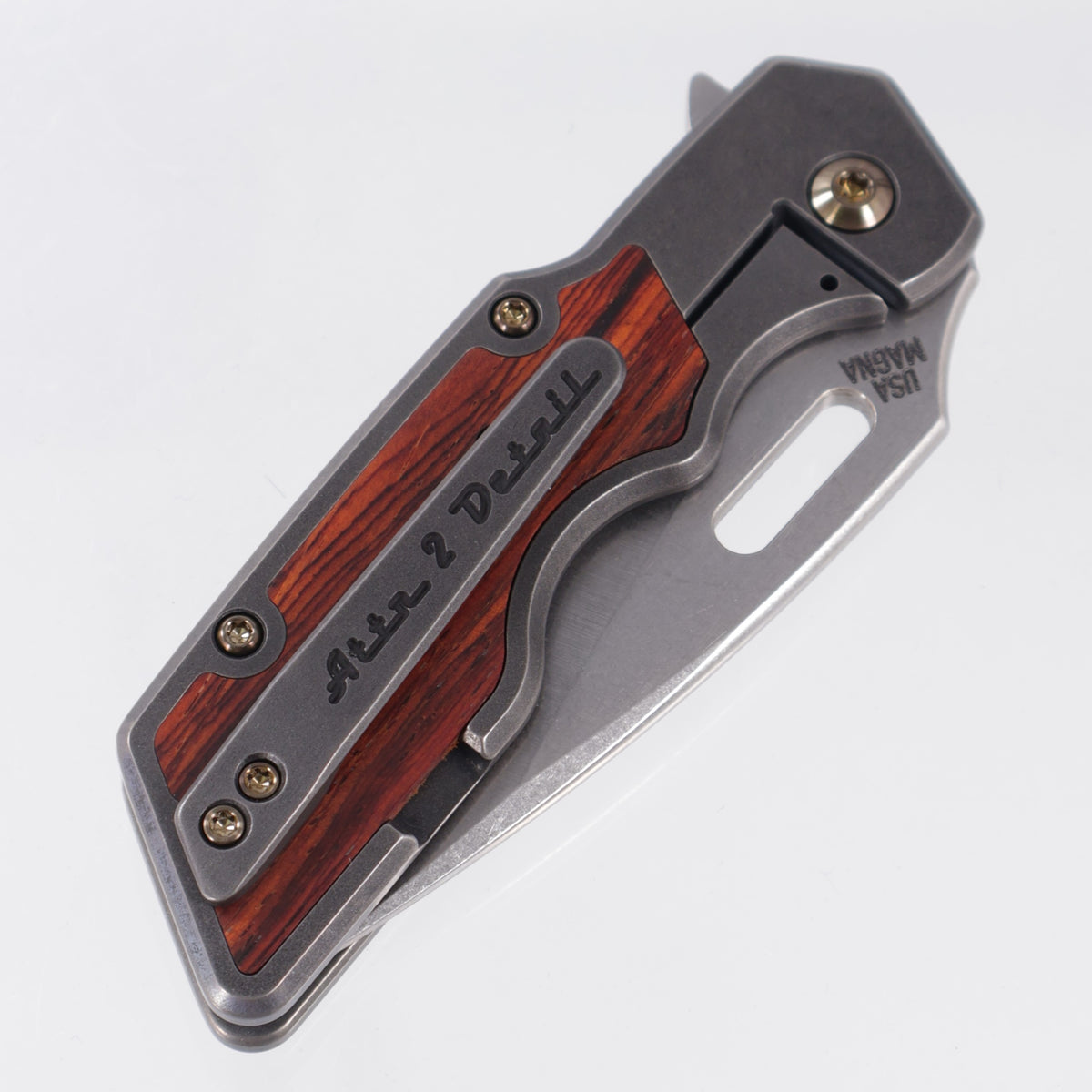 Attn2Detail Mercantile Mk.1 Medium Gen4 Drop Point Rising Grind - Blackened Titanium w/ Cocobolo Inlays & Gold Ano Hardware - Stonewash Satin Magnacut