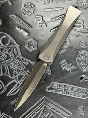 Pre Owned Heretic Knives Manticore X Hand Ground Vegas Forge Damascus DLC D/E & Two Tone DLC Hefted Stainless Steel Handle with Flamed Clip & CF Button