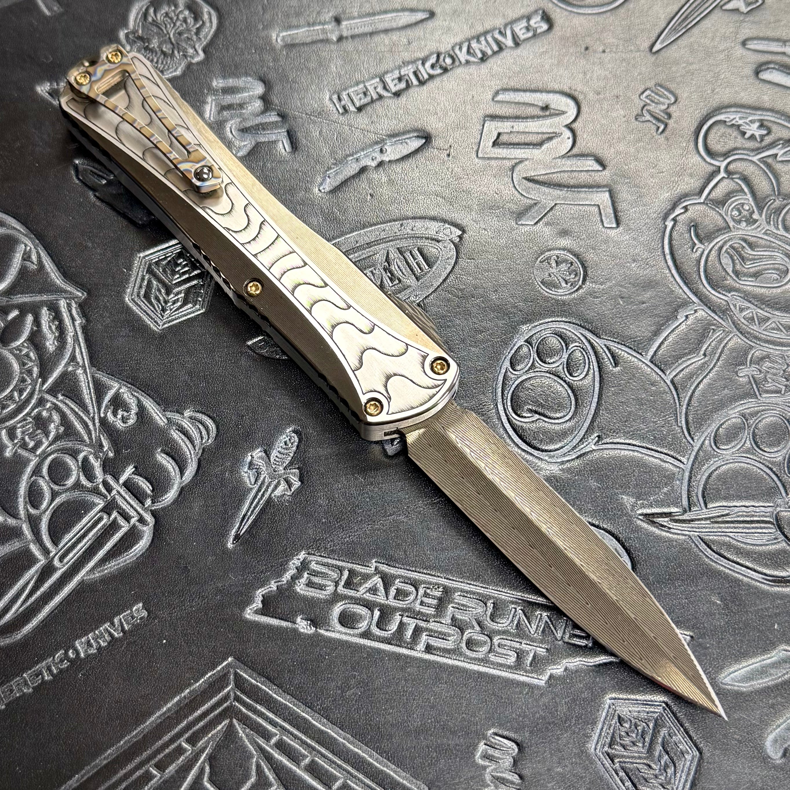 Heretic Manticore X Custom - Hand Engraved - Hand Ground DLC Vegas Forge Damascus Double Edge - 2 tone Hefted DLC stainless chassis - Flamed Ti Clip - Carbon Fiber Button S/N: 010
