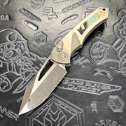Heretic Pariah Manual Custom - Single Cracked Ice - Hefted
Titanium Chassis w/ Green
Mammoth Inlays & Green Mammoth button inlay S/N: 006