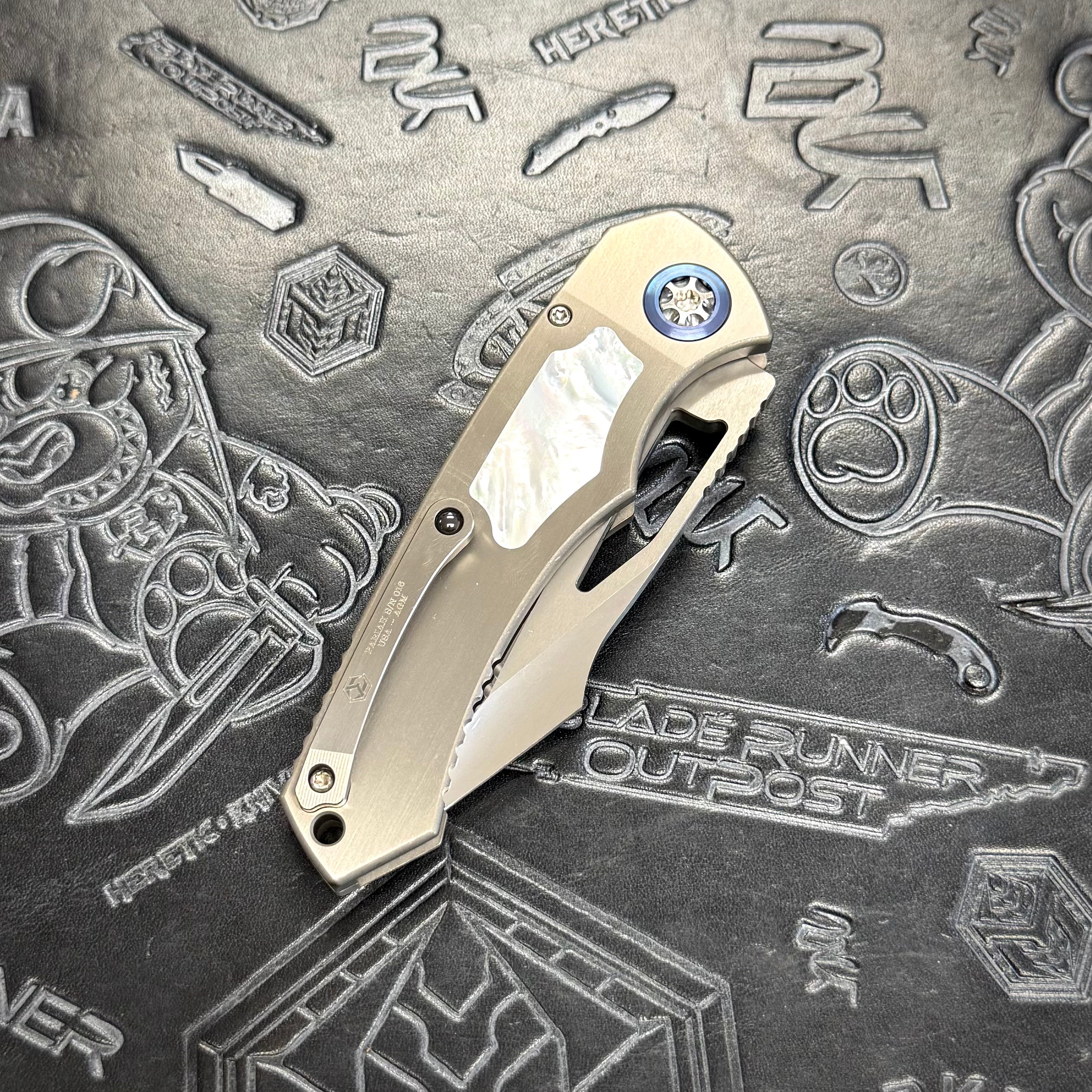 Heretic Pariah Manual Custom - Single Edge Mirror Polish - Hefted Titanium Chassis w/ Mother of Pearl inlays & Mother of Pearl button inlay - Blue Ti pivot collars
S/N: 016