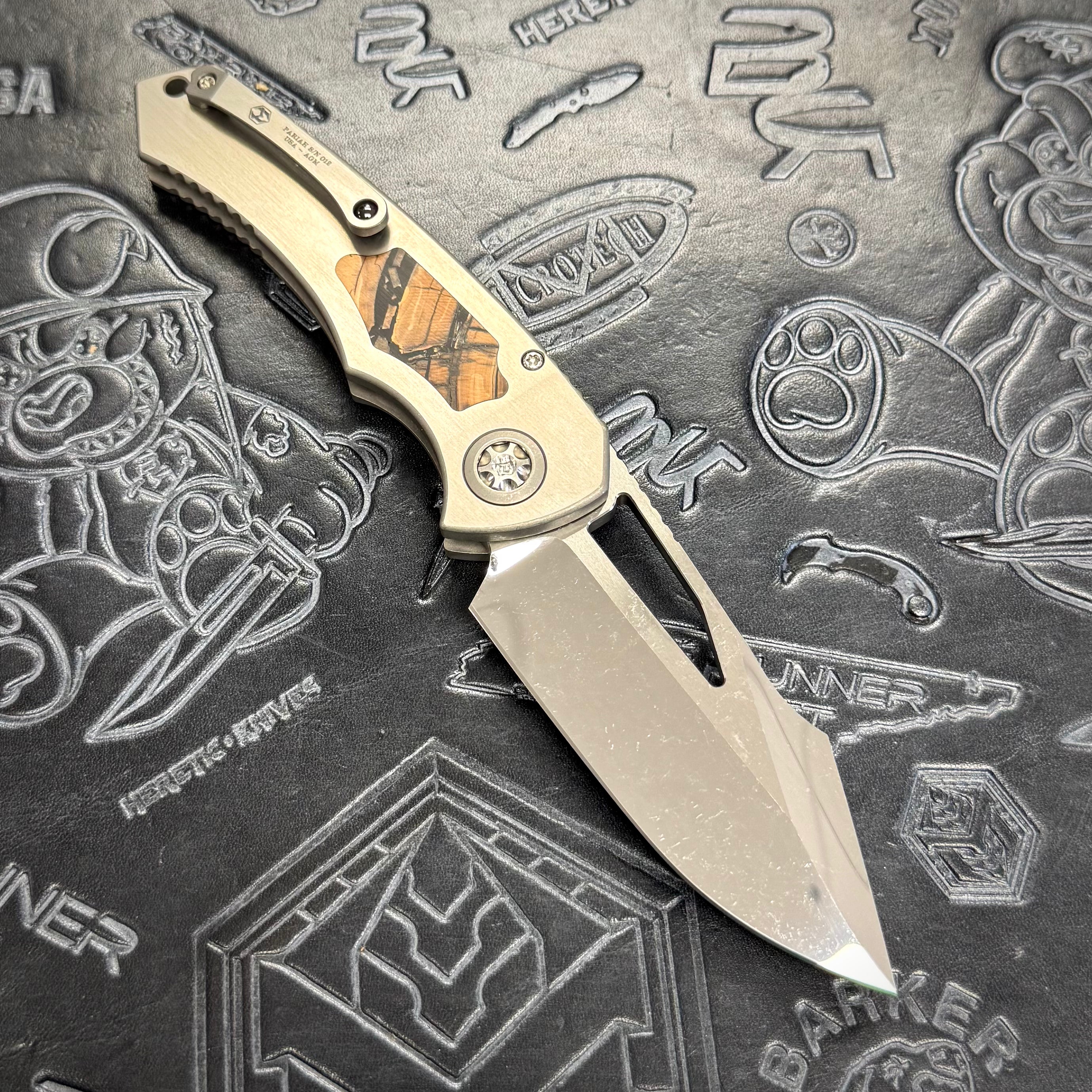 Heretic Pariah Manual Custom - Single Cracked Ice - Hefted
Titanium Chassis w/ Brown
Mammoth Inlays & Brown Mammoth button inlay S/N: 012