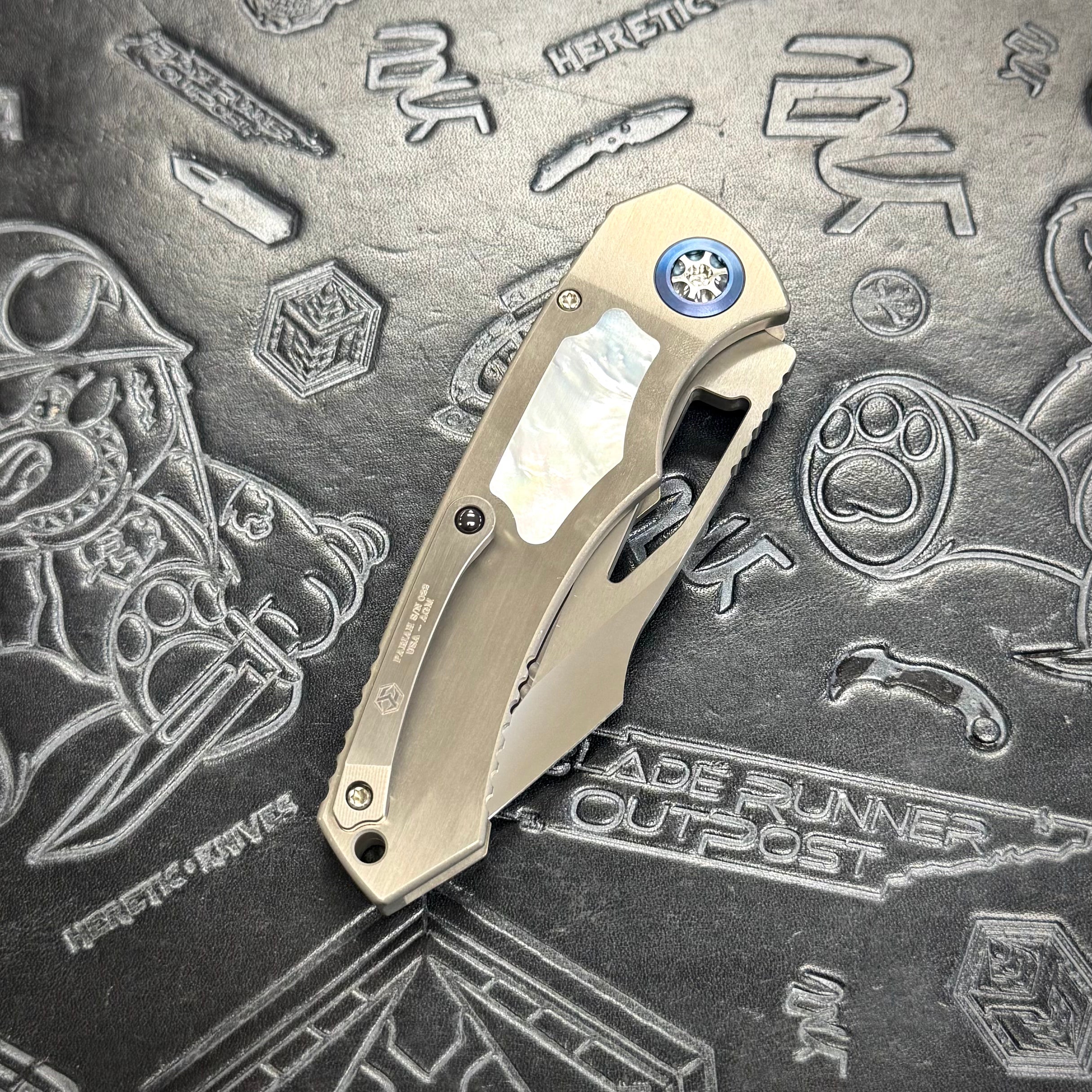 Heretic Pariah Manual Custom - Single Edge Mirror Polish - Hefted Titanium Chassis w/ Mother of Pearl inlays & Mother of Pearl button inlay - Blue Ti pivot collars
S/N: 022