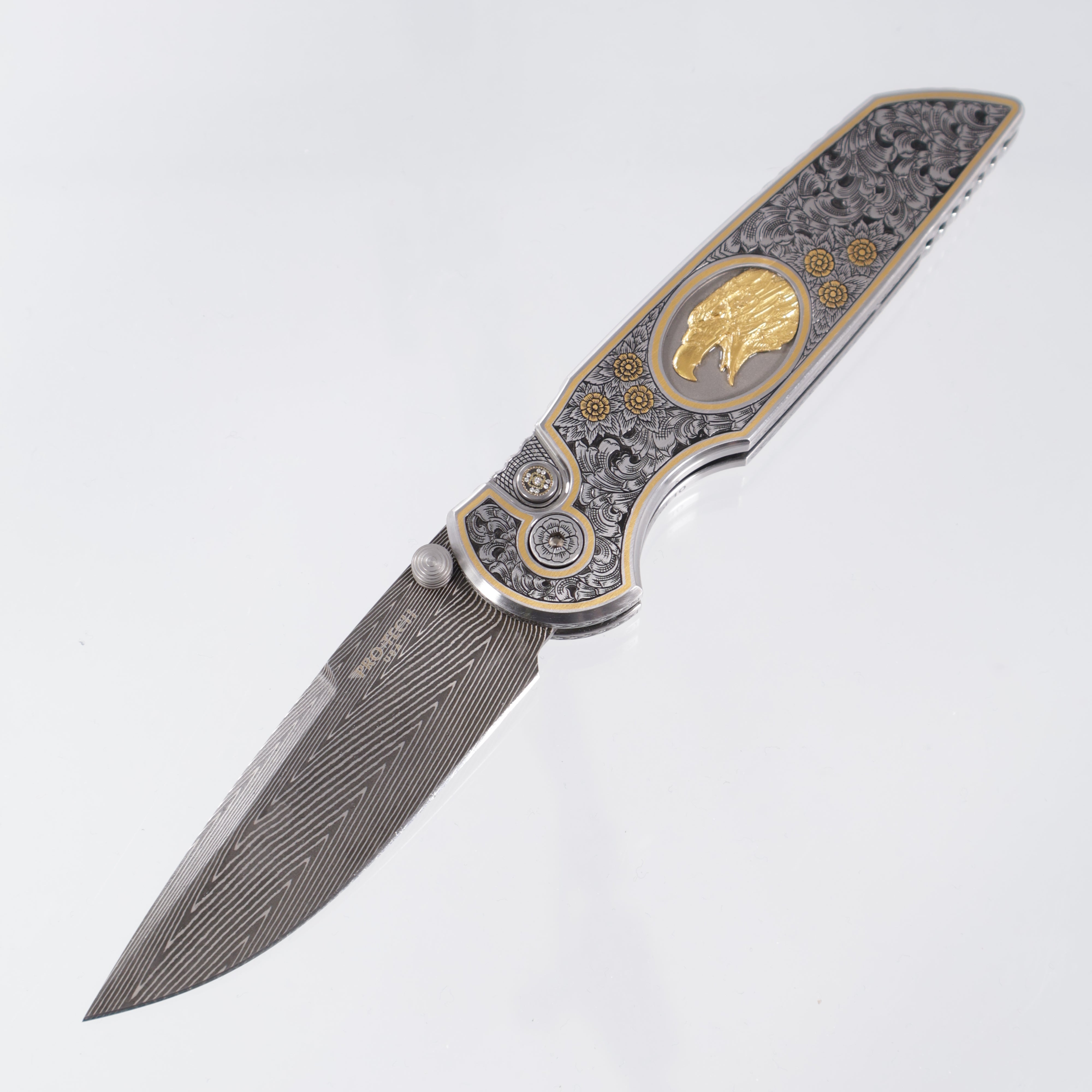 Pro-Tech TR-3 Integrity Gold & Steel Ultimate Custom #4 - Hand Engraved Deluxe Leafy Scroll Stainless chassis by Bruce Shaw w/ 24kt Gold Hand Sculpted Eagle inlay - Happy Jewelers Custom Mosaic Diamond button - Vegas Forge Carbon Herringbone Damascus